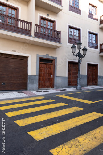 A classic street scene with bold yellow crosswalk stripes. of city traffic and pedestrian routes, representing the underlying structure and rules of urban transportation.