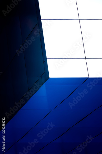 fragment of the wall of a modern blue building on a white background
