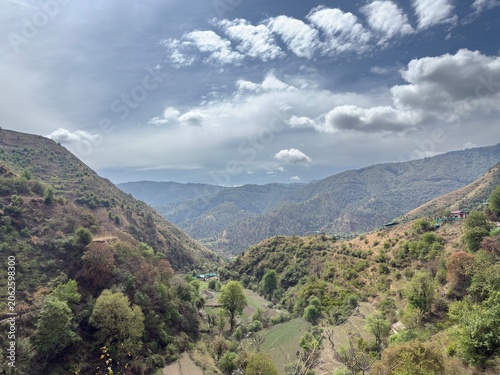 Where mountains touch the sky and clouds drift without a care.