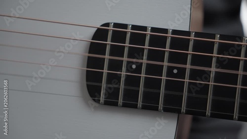 Close-Up of Guitar Strings Plucked with Pick, Vibration and Fade