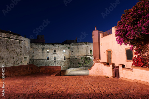 A road among the historic buildings of Otranto, a medieval town in the evening, Italy.