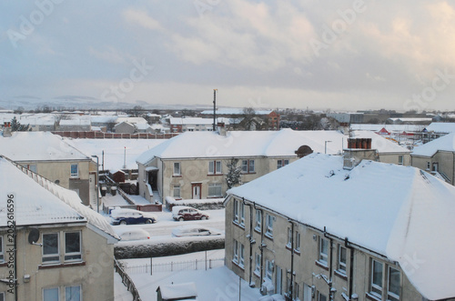 Картината върху платно Winter View of Snow Covered Residential Buildings and Gardens