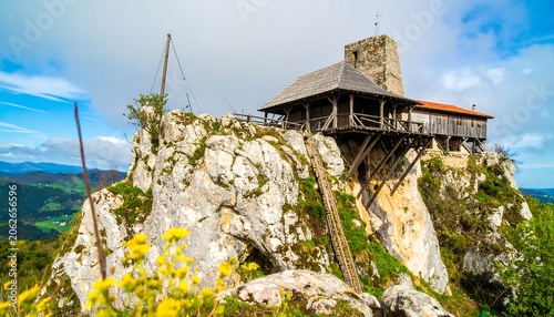 Wooden chalet on a rocky mountain peak