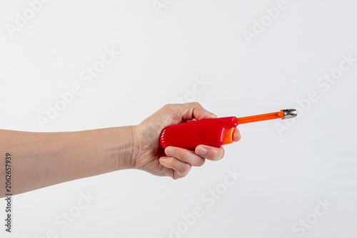 Photos Red gas lighter gun for gas-stove and hand isolated on white background