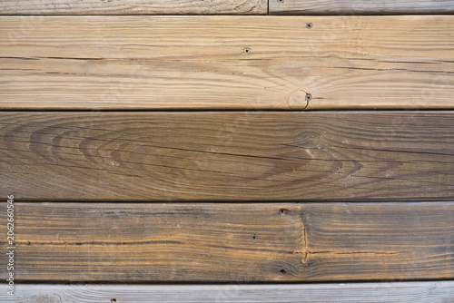 Weathered wooden plank wall with natural grain and knots