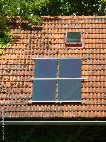 Old Bavarian tiled roof with solar photovoltaic panels, detail