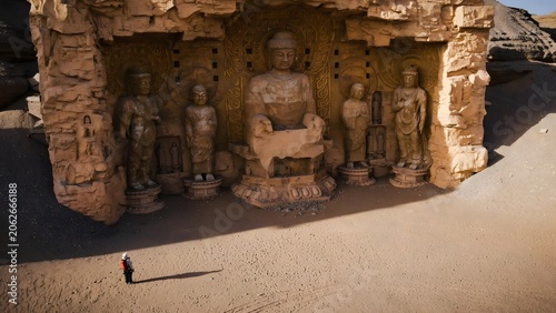 Traveler at the Mogao Caves Buddha sculptures in Dunhuang, China