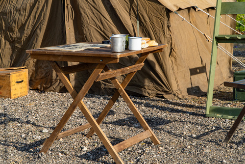 Foto table with retro newspaper on a world war II Allied camp reenactment