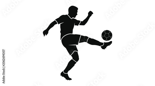 Silhouette of a soccer player kicking a ball during a game.