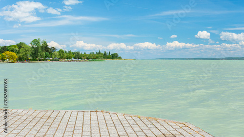 Hungary, Lake Balaton, a jetty on the shore with a view of the lake and the other shore on a sunny summer day.