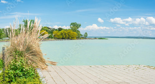 Hungary, Lake Balaton, a jetty on the shore with a view of the lake and the other shore on a sunny summer day.