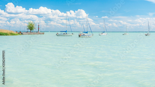 Hungary, Lake Balaton, sailboat moored on the water, view of the other side of the lake on a sunny summer day.