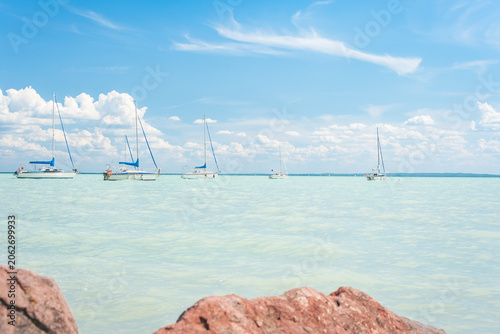 Hungary, Lake Balaton, sailboat moored on the water, view of the other side of the lake on a sunny summer day.