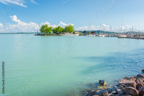 Hungary, Lake Balaton, a marina for small boats on the shore with a view of the lake and the other shore on a sunny summer day.