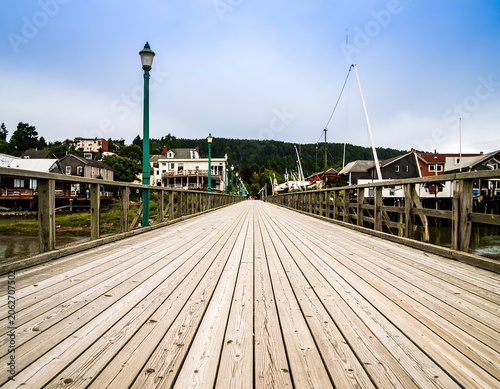 Wooden pier extending into a harbor town