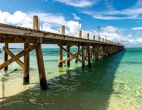 Wooden pier extending into turquoise water