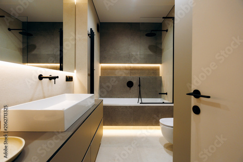 Modern minimalist bathroom interior with bathtub and vanity
