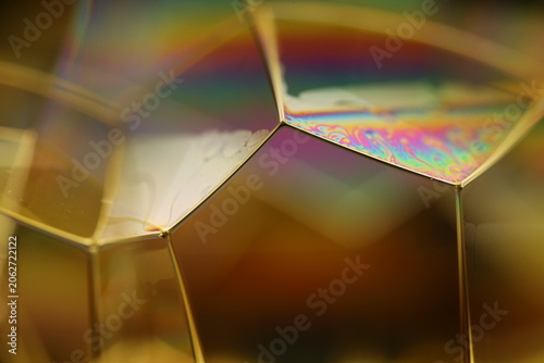 Bild auf Leinwand Abstract Macro Shot of Golden Crystalline Lattice and Iridescent Nanotechnology Surface Patterns