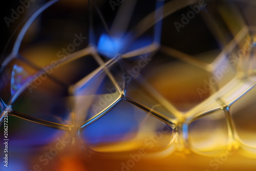 Photos Abstract microscopic liquid cell geometry with gold and blue iridescence