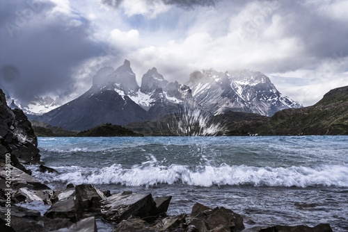 Cuernos del Paine, wind-whipped Lago Pehoé with spray and waves in the foreground, cloudy sky, Torres del Paine National Park, Magallanes region, Patagonia, Chile