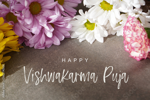 happy vishwakarma puja. greeting card with colorful fresh flowers