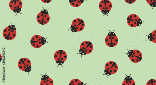 Seamless pattern with red ladybugs on a green background