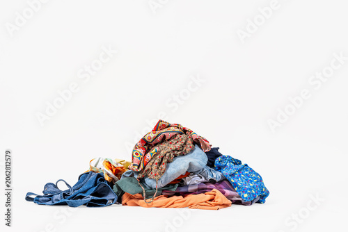 Pile of unfolded laundry against white background
