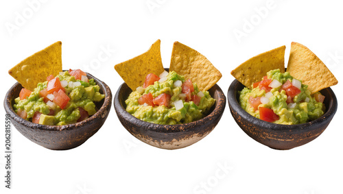 Photography Three rustic bowls of fresh guacamole with diced tomatoes and onions served with