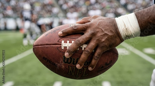 American football player holding ball.