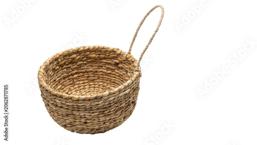 Foto Small round woven straw basket with a handle for storage and home organization