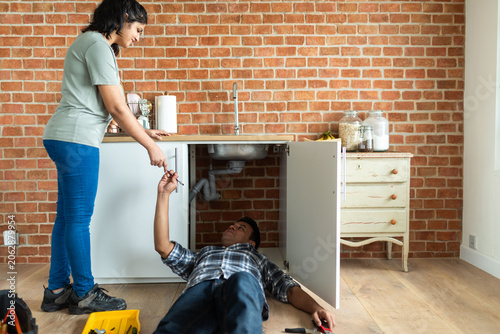 Photography Couple fixing kitchen sink together
