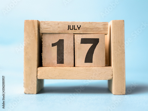 Photos A wooden block calendar for July 17th on a light blue background.