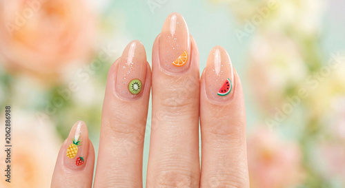 Nail photo for summer manicure ideas with tiny fruit art and peach glossy polish