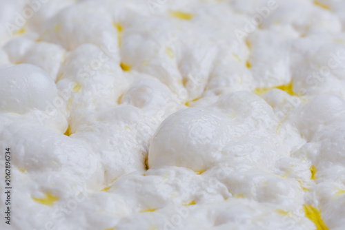 Naturally fermented sourdough focaccia dough during the final proofing stage. The dough surface is filled with air bubbles artisan bread-making process and traditional natural leavening techniques.