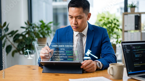 Professional compliance officer reviewing digital checklist on tablet in modern office