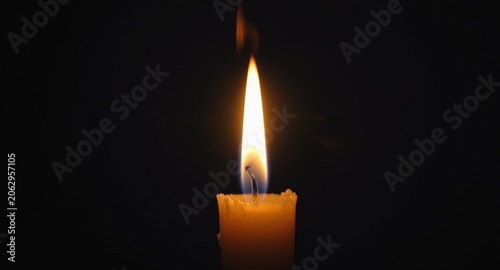 Burning Candle Flame Illuminating Dark Night for Serene Ambience