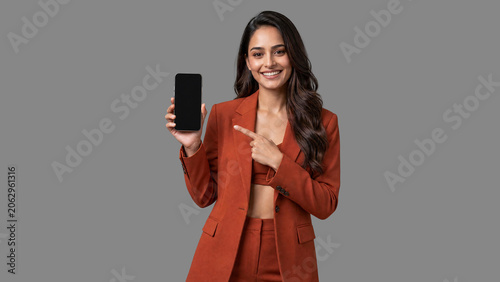 South Asian Female Entrepreneur Showing Smartphone Screen For Mobile App Promotion generative ai