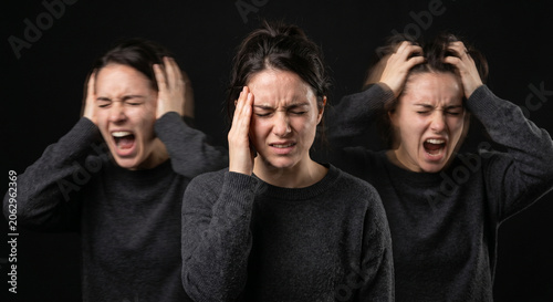 Conceptual portrait of a distressed woman with motion blur effects depicting severe mood swings, inner conflict, panic, and symptoms of bipolar disorder
