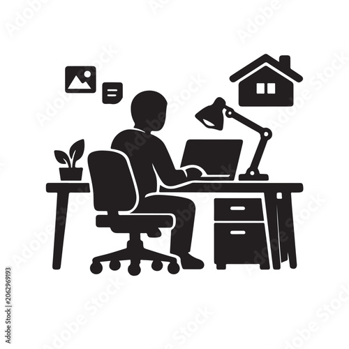 Remote worker on laptop at home office desk with lamp
