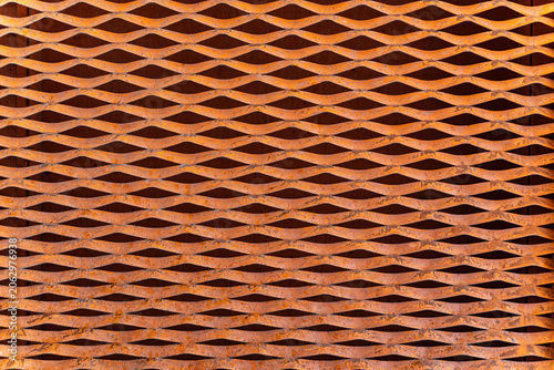 Obraz na plátně Close-up of a rusty, orange metal expanded metal mesh texture