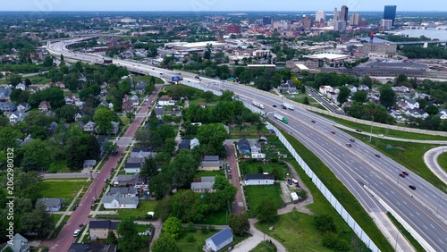 Aerial View of Downtown Toledo Ohio Cityscape with cars traveling interstate highway past urban homes