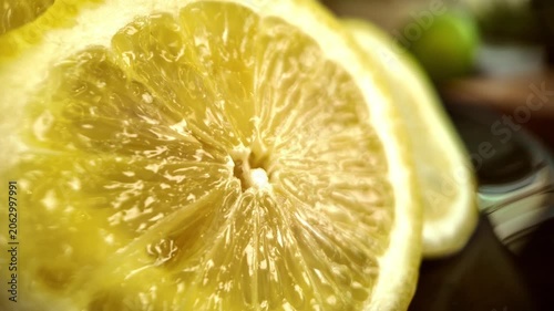 Fresh lemon slice macro close up moving light reflections citrus fruit texture juicy food background
