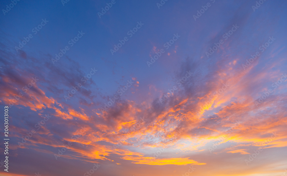 Fototapeta premium Vibrant Purple and Orange Sunset Sky,A breathtaking twilight sky featuring a beautiful gradient of vibrant purple, pink, and soft orange hues as the sun sets over the horizon, creating a peaceful and 