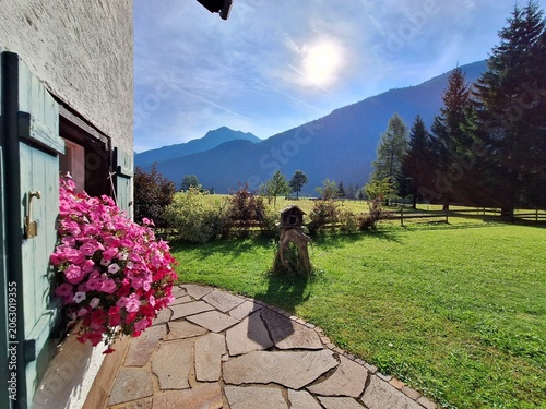Konstfotografi Flower decorated alpine guesthouse terrace with mountain view in Tyrol, Austria