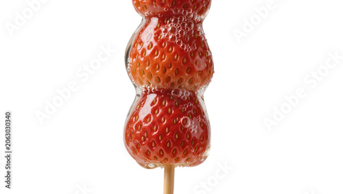 Sweet candied strawberries on a stick coated in glossy sugar, isolated on transparent background
