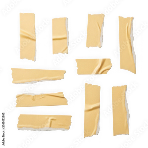 Collection of torn masking tape pieces on a white background.