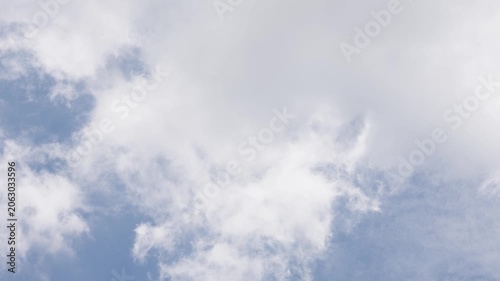 Sky Filled with Wispy Clouds: A vast expanse of bright blue sky is dotted with ethereal, wispy clouds, creating a sense of openness and serenity.