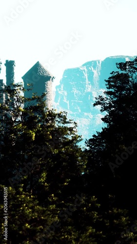 A castle is viewable through a thick line of trees with mountains in the background. The scene shows bright daylight and clear visibility of the landscape.