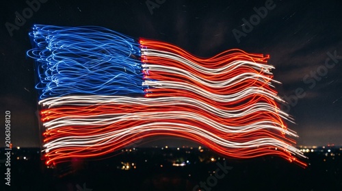 American Flag Created with Light Painting in Night Sky, Patriotic USA Symbol with Red White and Blue Light Trails Isolated on Dark Background