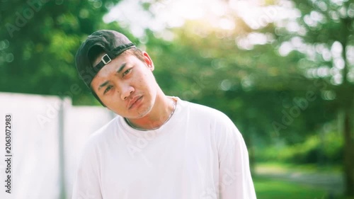 Curious young Southeast Asian man looking at the camera